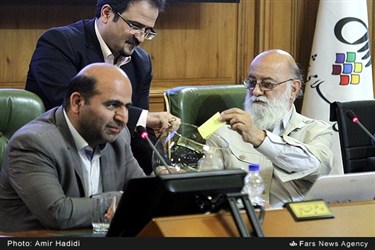 مهدی چمران در حال انداختن برگه رای انتخابات رئیس شورای شهر تهران به گلدان