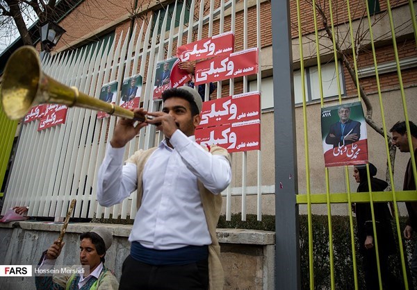 A musician performed in front of campaign posters in Tehran