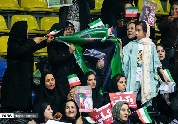 Women held campaign posters during an election rally in Tehran