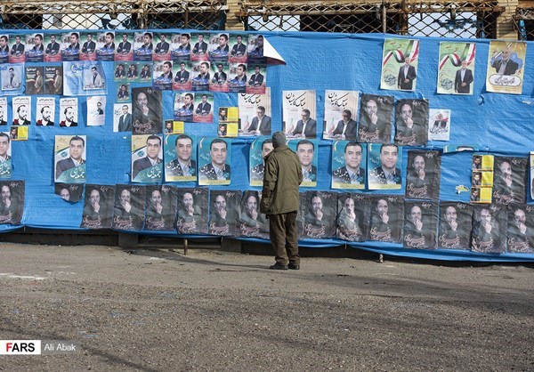 A man stopped to read campaign posters in Tehran