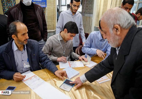 A man verified his identity with a finger print before submitting his ballot