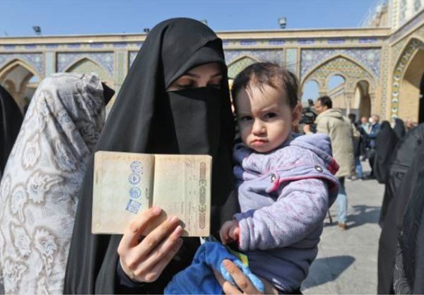 A woman poses with her child in Tehran